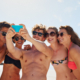 Group of people taking a beach selfie