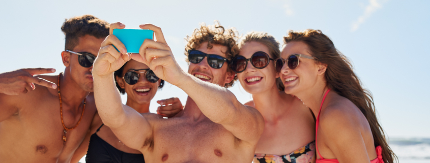 Group of people taking a beach selfie